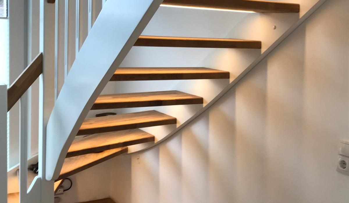 Offene Holztreppe mit weißem Geländer und integrierter LED-Beleuchtung