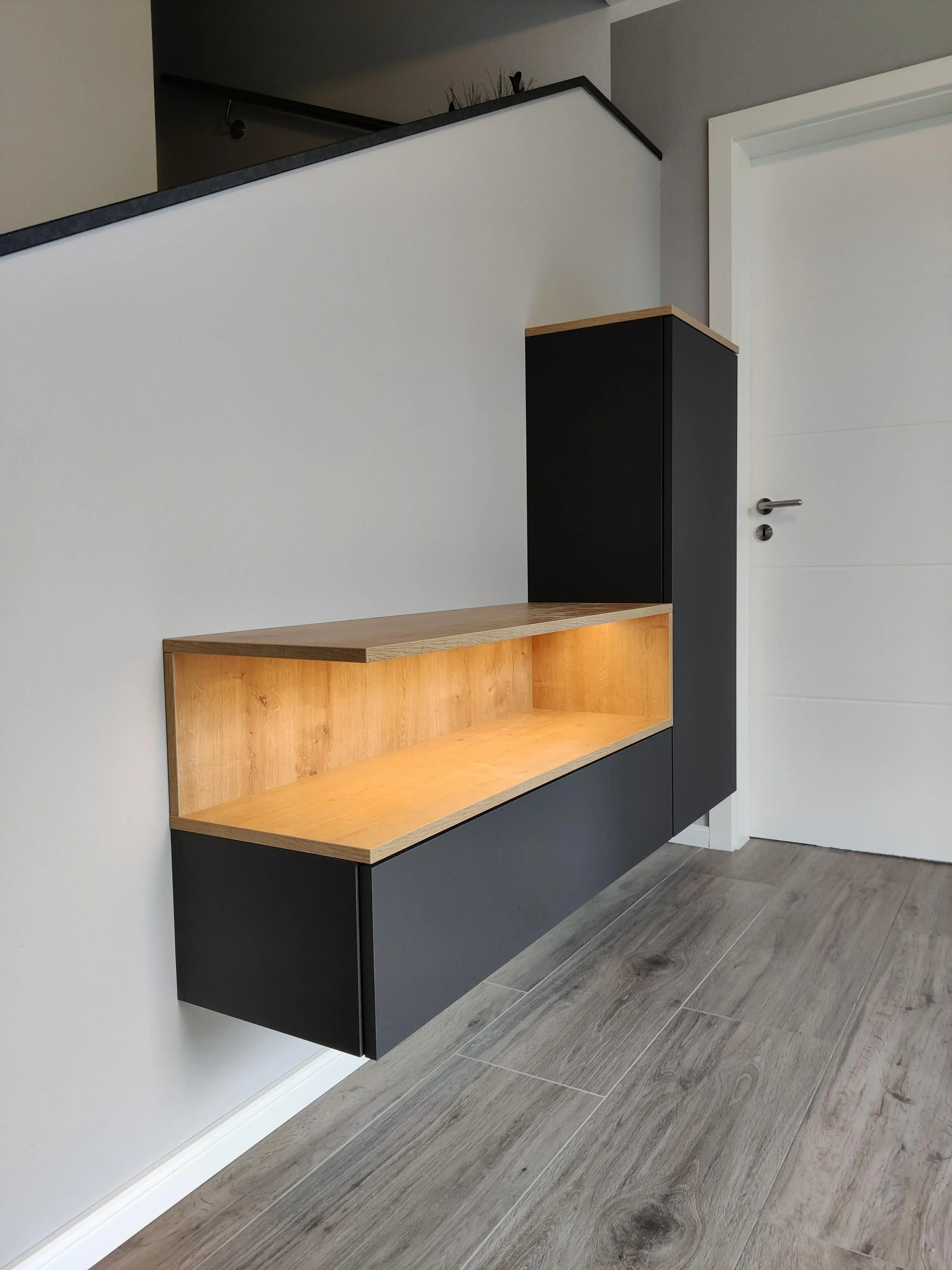 Schwebende Flurgarderobe in Schwarz und Holzoptik mit integrierter Beleuchtung